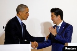 FILE - U.S. President Barack Obama shakes hands with Japan's Prime Minister Shinzo Abe after a bilateral meeting during the 2016 Ise-Shima G7 Summit in Shima, Japan, May 25, 2016.