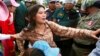 FILE - Tep Vanny of Boeung Kak Lake is blocked by riot police during a protest rally near the prime minister's residence in Phnom Penh, Cambodia, July 2, 2013. 