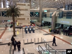 Airport staff gather near a security checkpoint at Cairo International Airport, March 21, 2017.