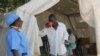 FILE: A medical staff member (left) administers oral rehydrating solution to a cholera patient to replace fluids he lost through diarrhea, in Harare, Zimbabwe, Sept. 12, 2018, (C. Mavhunga/VOA) 