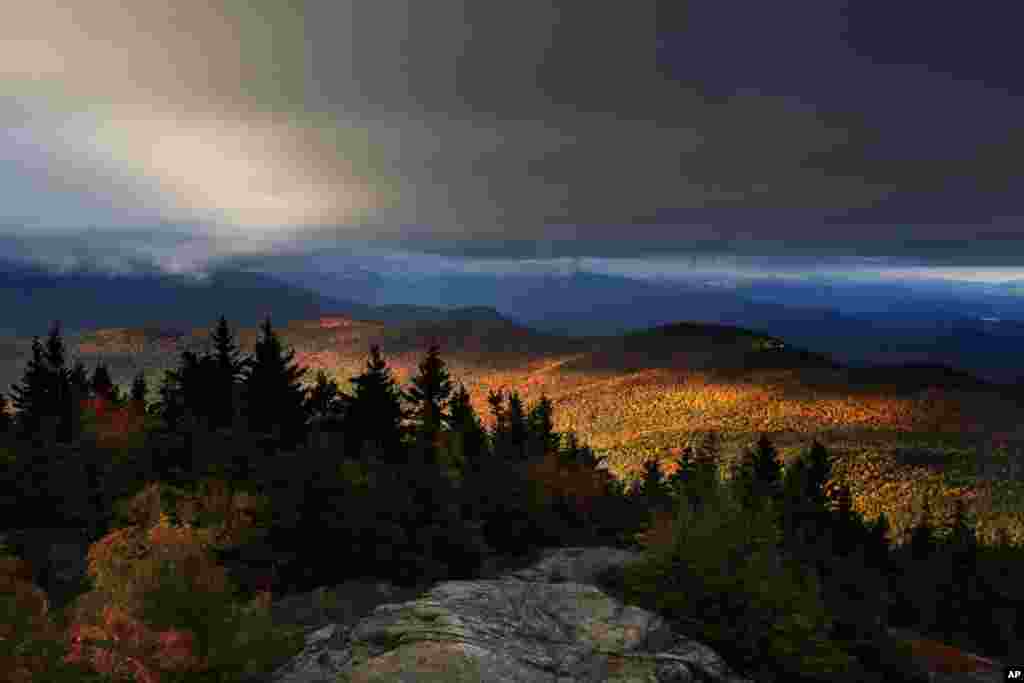 Fall foliage colors a line of mountains in Chatham, New Hampshire.