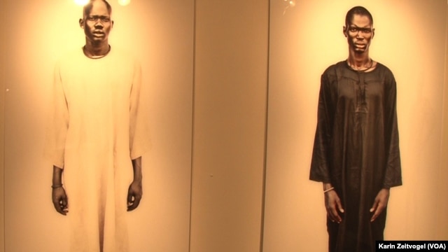 Two cattle herders from the Lakes state village of Yirol who posed for American photographer Tim Freccia and feature in Freccia's "Life and Death" exhibit.