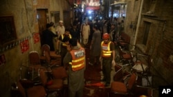 Pakistani rescue volunteers visit at a site of blast in Peshawar, Pakistan, July 10, 2018. 