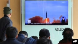 People watch a TV screen showing file footage of North Korea's missile launch at Seoul Railway Station in Seoul, South Korea, Nov. 21, 2017.