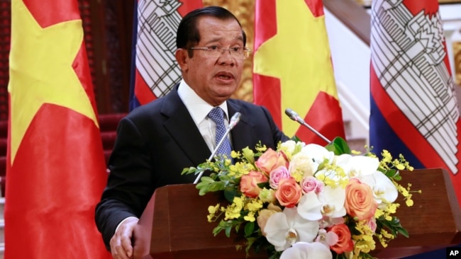 Cambodian Prime Minister Hun Sen speaks to reporters during a joint press briefing with his Vietnamese counterpart Nguyen Xuan Phuc in Hanoi, Vietnam, Dec. 7, 2018.