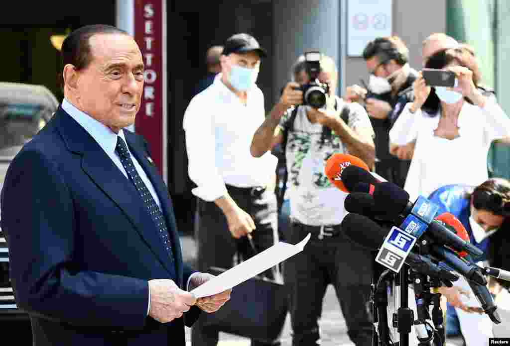 Former Italian Prime Minister Silvio Berlusconi speaks to the media as he leaves Milan&#39;s San Raffaele hospital, where he was being treated after he was confirmed to have COVID-19 with mild pneumonia, in Milan.