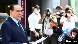 FILE - Former Italian Prime Minister Silvio Berlusconi speaks to the media as he leaves Milan's San Raffaele hospital, where he was being treated after testing positive for the coronavirus disease (COVID-19) and diagnosed with mild pneumonia, in Milan, Italy, September 14, 2020. 