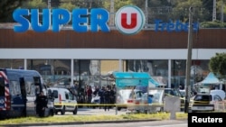 A general view shows gendarmes and police officers at a supermarket after a hostage situation in Trebes, France, March 23, 2018. 