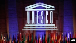 FILE - The logo of the United Nations Educational, Scientific and Cultural Organisation (UNESCO) is seen druing a conference at UNESCO headquarters in Paris, France, Nov. 4, 2017. 