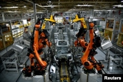 FILE - Autonomous robots assemble an X model SUV at the BMW manufacturing facility in Greer, South Carolina, U.S. November 4, 2019. (REUTERS/Charles Mostoller)