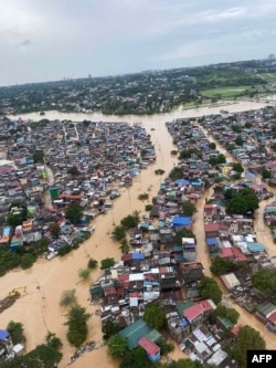 This handout photo taken on November 12, 2020 and received from the office of Philippine Senator Bong Go shows an aerial view of flooding during an aerial survey with President Rodrigo Duterte around Manila, after Typhoon Vamco hit the capital city. (Phot