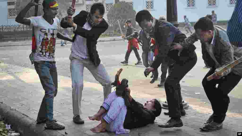 Supporters of the ruling Bangladesh Awami League beat a lawmaker and supporter of the main opposition Bangladesh Nationalist Party (BNP) during a protest by opposition activists in Dhaka, Bangladesh, Dec. 29, 2013. Security forces and opposition activists clashed in the capital, leaving at least one person dead, as thousands of police took to the streets to foil a mass rally calling on Prime Minister Sheikh Hasina to cancel upcoming elections.