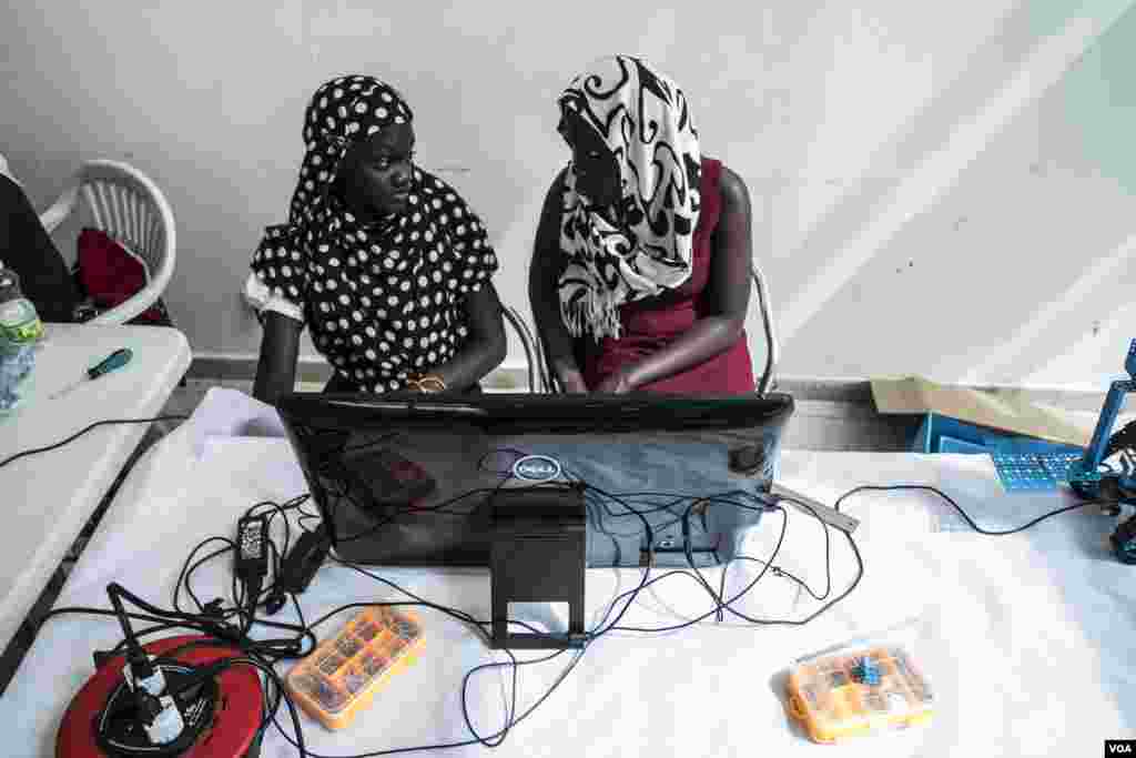 Ndeye Astou Kebe, 16, and Rokyaha Cisse, 17, from Dakar, read results from their team's robot at the 2017 Pan-African Robotics Competition in Dakar, Senegal, May 19, 2017. Their robot sends sounds into the ground, which detect the presence of metal. (R. 