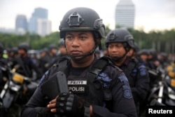 Mobile brigade policemen stand during a ceremony ahead of the Christmas and New Year's celebrations in Jakarta, Indonesia, Dec. 21, 2017.