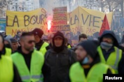 FILE - Protesters wearing yellow vests take part in a demonstration of the "yellow vests" movement in Marseille, France, Jan. 26, 2019.