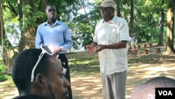 Ron Freeman, in tan cap, runs a training session for mentors in a girls' double Dutch jump rope program in Conakry, Guinea. Beside him is program coordinator Prince Owusu. (Carol Guensburg / VOA)