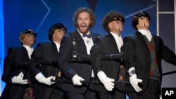 Host T.J. Miller, center, performs on stage at the 21st annual Critics' Choice Awards at the Barker Hangar in Santa Monica, Calif., Jan. 17, 2016.