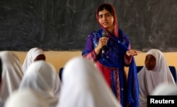 FILE - Pakistani Nobel Peace Prize laureate Malala Yousafzai addresses students at the Nasib Secondary School in Ifo2 area of Dadaab refugee camp during celebrations to mark her 19th birthday near the Kenya-Somalia border, July 12, 2016.