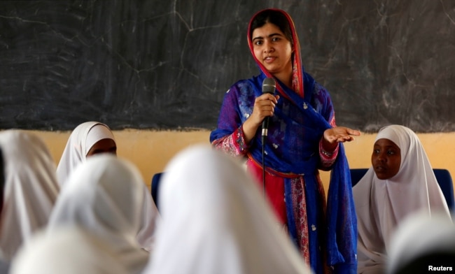 FILE - Pakistani Nobel Peace Prize laureate Malala Yousafzai addresses students at the Nasib Secondary School in Ifo2 area of Dadaab refugee camp during celebrations to mark her 19th birthday near the Kenya-Somalia border, July 12, 2016.