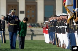 South Korean President Park Geun-hye bows to the colors as she reviews the troops during a full military honors parade to welcome her at the Pentagon in Washington, Oct. 15, 2015.