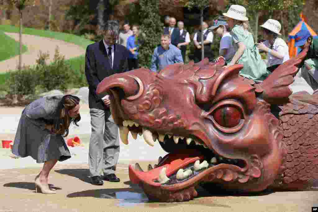 Britain&#39;s Kate, Duchess of Cambridge views one of the installations during a tour and official opening of the new Magic Garden at Hampton Court Palace in London.