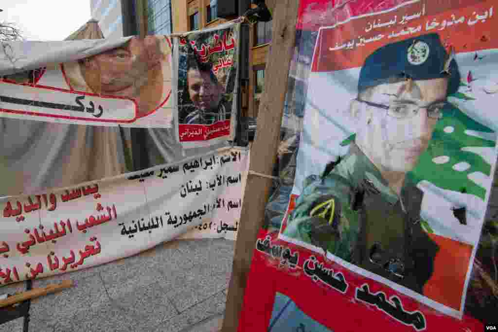 Images of the servicemen being held captive are spread throughout the encampment. (John Owens/VOA)