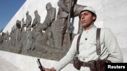 FILE - A Turkish soldier in historical uniform stands at a ceremony marking the 100th anniversary of the Battle of Canakkale, as part of the Gallipoli campaign in Gallipoli, Turkey, March 18, 2015. 