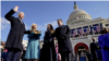 Joe Biden is sworn in as the 46th president of the United States by Chief Justice John Roberts as Jill Biden holds the Bible during the 59th Presidential Inauguration at the U.S. Capitol.