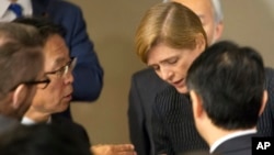 Motohide Yoshikawa, left, Japan's ambassador to the United Nations, talks with Samantha Power, the U.S. ambassador, following a Security Council meeting at U.N. headquarters, Sunday, Feb. 7. Some are pushing for the UN to name its first woman secretary-general. (AP Photo/Mark Lennihan)