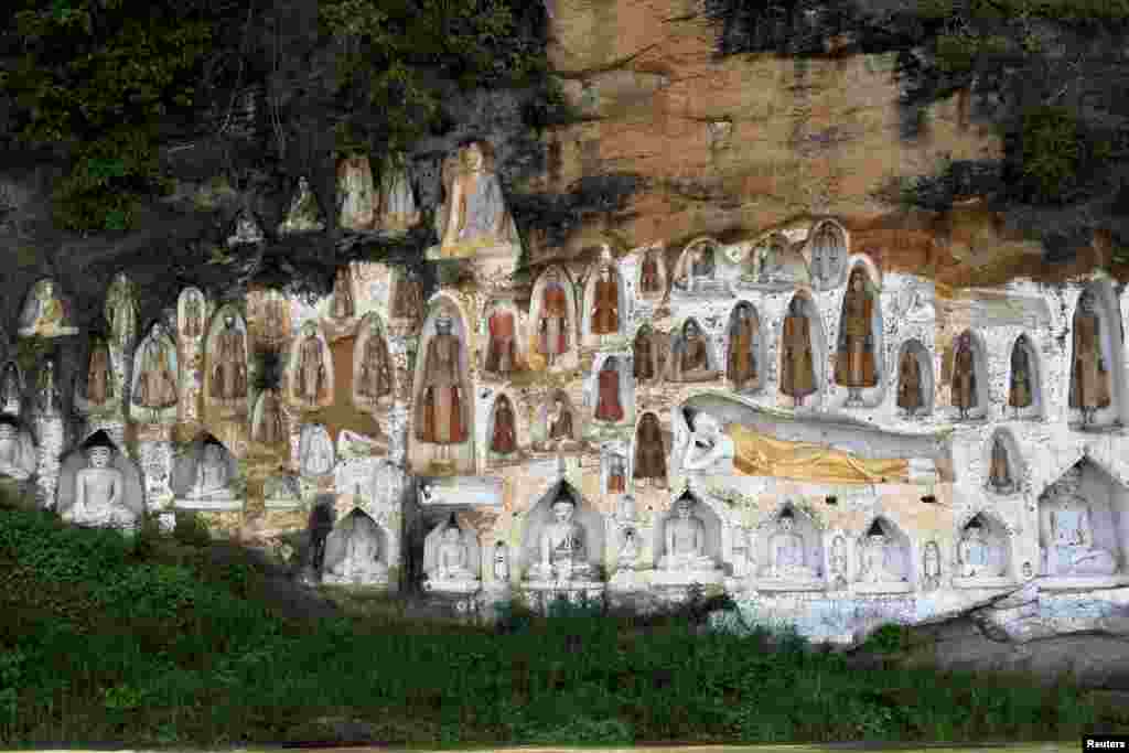 Buddha images, carved into cliffs are seen at Akauk Taung (Tax Mountain) on the bank of the Irrawaddy River outside Htonebo, Bago division, Myanmar.