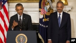 President Barack Obama, accompanied by Attorney General Eric Holder, speaks in the State Dining Room of the White House, Sept. 25, 2014, to announce Holder is resigning.