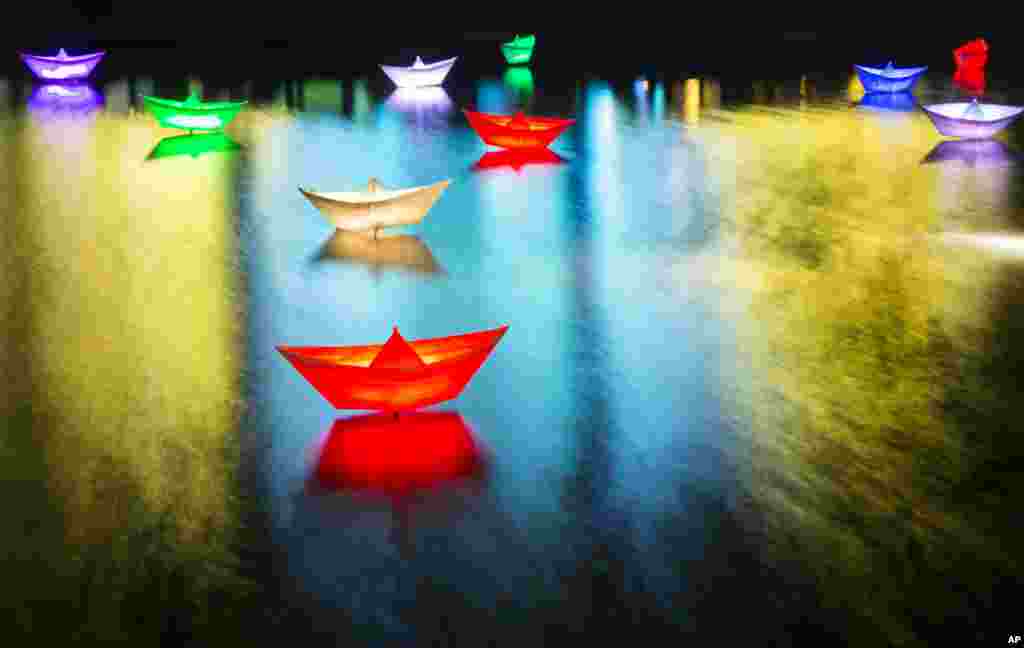 Lamps shaped as ships are seen in a water basin next to Potsdam Square during the first Berlin Light Festival in Berlin, Germany, Oct. 4, 2013.