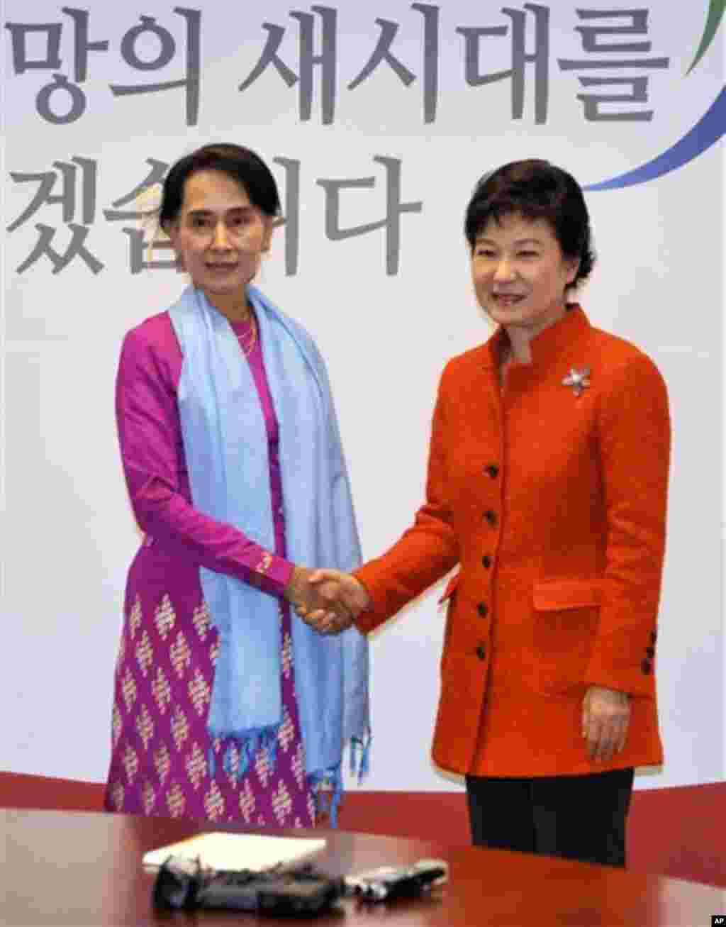 Myanmar opposition leader Aung San Suu Kyi, left, shakes hands with South Korean president-elect Park Geun-hye during their meeting in Seoul, South Korea Tuesday, Jan. 29, 2013. The meeting between two of the most prominent women in Asia spotlights a tra