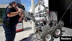 A Cleveland police bomb squad technician loads a Remotec F5A explosive ordnance device robot during a demonstration of police capabilities near the site of the Republican National Convention in Cleveland, Ohio, July 14, 2016. 