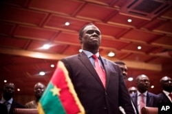 Burkina Faso's transitional president Michel Kafando attends the official handover ceremony returning him to office in Ouagadougou, Burkina Faso, Wednesday, Sept. 23, 2015.