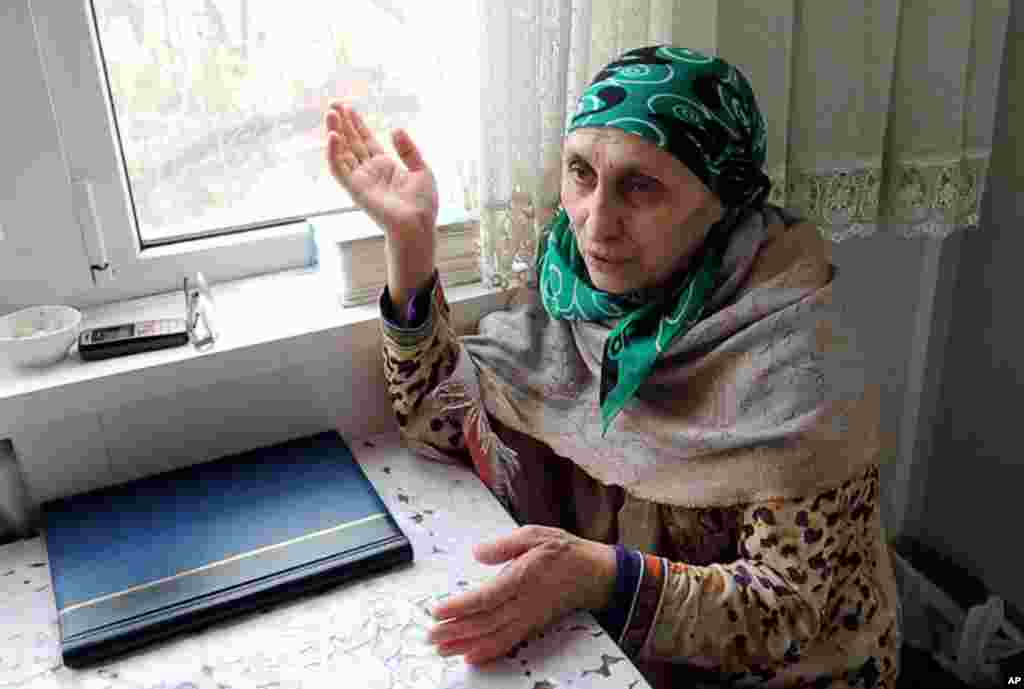 Patimat Suleimanova, the aunt of the Boston bomb suspects, speaks to The AP in her home in Makhachkala, Russia. Suleimanova says Tamerlan Tsarnaev struggled to find himself while trying to reconnect with his Chechen identity on a trip to Russia last year.