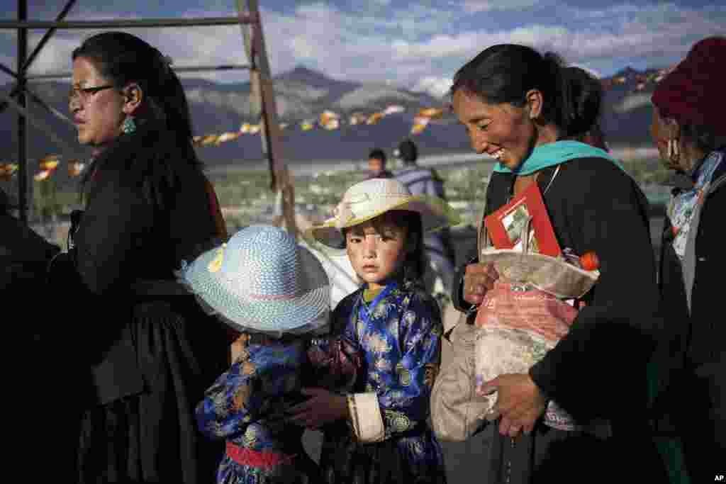 Buddhist devotees wait in line to get inside the venue of the Dalai Lama&#39;s teachings on the fifth day of Kalachakra near Leh, India.