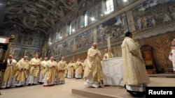 FILE - Pope Francis leads a a mass with cardinals at the Sistine Chapel at the Vatican.