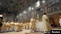 FILE - Pope Francis lead a mass with cardinals at the Sistine Chapel, in a picture released by Osservatore Romano at the Vatican, March 14, 2013. 