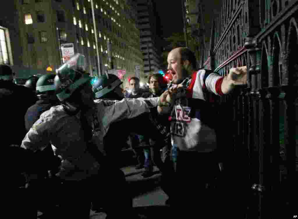 Protester Brent Schmidt of Brooklyn, N.Y., is arrested by police near the Occupy Wall Street encampment at Zuccotti Park in New York, early Tuesday, Nov. 15. At about 1 a.m. Tuesday, police handed out notices from the park's owner and the city saying that