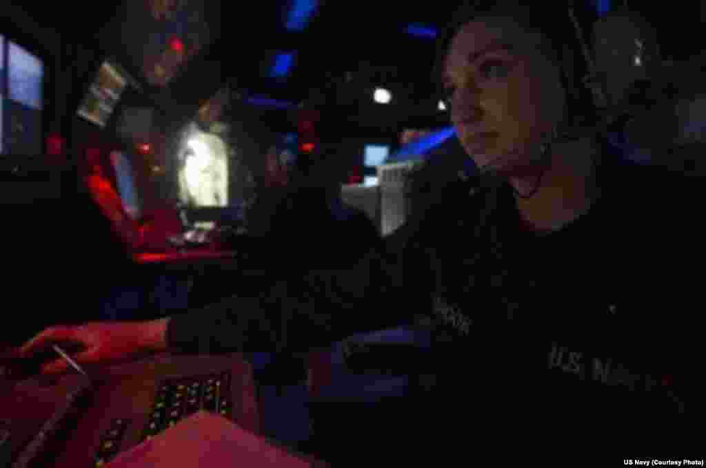 Operation Specialist Seaman Brianna Holbrook assigned to the Arleigh Burke-class guided-missile destroyer USS Halsey (DDG 97), stands watch in the ship’s combat information center during exercise Valiant Shield 2014, Sept. 20, 2014.