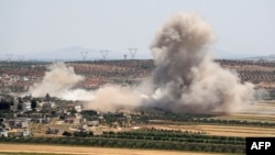 Smoke billows during reported Syrian government forces' bombardments on the village of Sheikh Mustafa in the southern countryside of the jihadist-held Idlib province, May 27, 2019. 