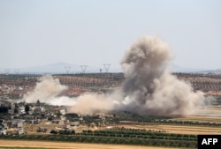 Smoke billows during reported Syrian government forces' bombardments on the village of Sheikh Mustafa in the southern countryside of the jihadist-held Idlib province, May 27, 2019.