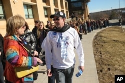 People wait in line for a rally Democratic presidential candidate Hillary Clinton at Abraham Lincoln High School in Council Bluffs, Iowa, Jan. 31, 2016.