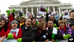 FILE - Rep. Luis Gutierrez (D-Illinois), third from left, along with other demonstrators protest outside of the U.S. Capitol in support of the Deferred Action for Childhood Arrivals (DACA) during a rally on Capitol Hill in Washington, Dec. 6, 2017.