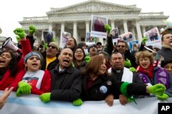 FILE - Rep. Luis Gutierrez (D-Illinois), third from left, along with other demonstrators protest outside of the U.S. Capitol in support of the Deferred Action for Childhood Arrivals (DACA) during a rally on Capitol Hill in Washington, Dec. 6, 2017.