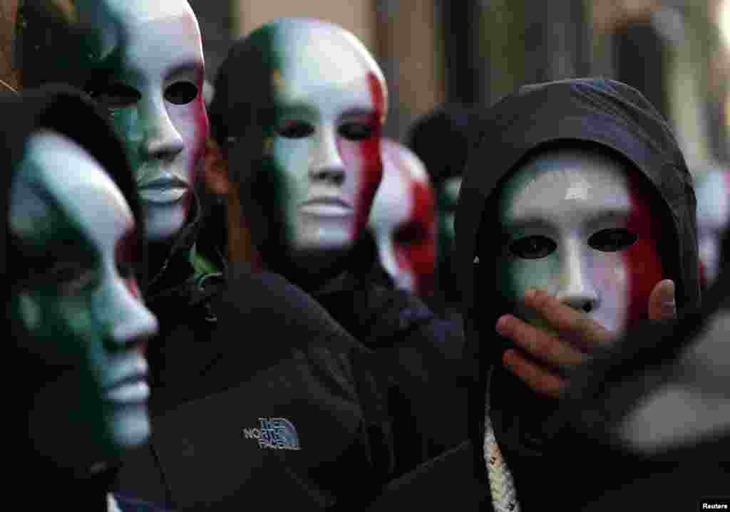 Members of Casapound far-right organization wear masks in the colors of the Italian flag before a demonstration organized by "People from pitchfork movement" to protest against economic insecurity and the government in downtown Rome.