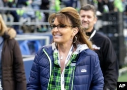 FILE - Sarah Palin, political commentator and former governor of Alaska, walks on the sideline before an NFL football game between the Seattle Seahawks and the Los Angeles Rams, in Seattle, Dec. 15, 2016. Palin's spokesman told The Associated Press Thursday that reports that she was in a coma following a car accident are not true.