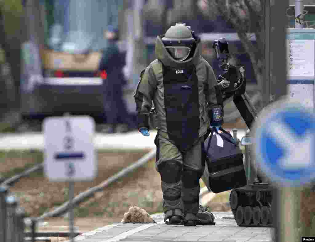A bomb disposal expert takes part in a search in the Brussels borough of Schaerbeek following Tuesday's bombings in Brussels, Belgium.