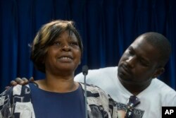 Audrey DuBose, mother of Samuel DuBose, is comforted by her son Aubrey as she speaks to the media after murder and manslaughter charges against University of Cincinnati police officer Ray Tensing were announced.